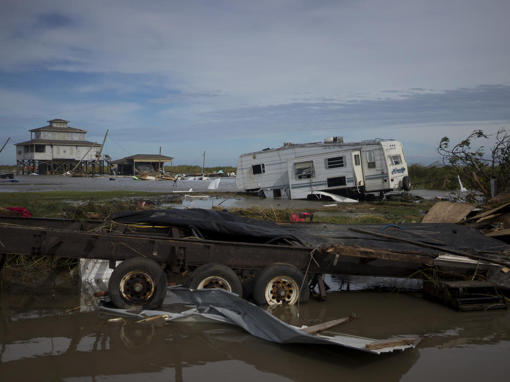 A trailer is left damaged and debris scattered Thursday in Holly Beach, La., in the aftermath of Hurricane Laura.