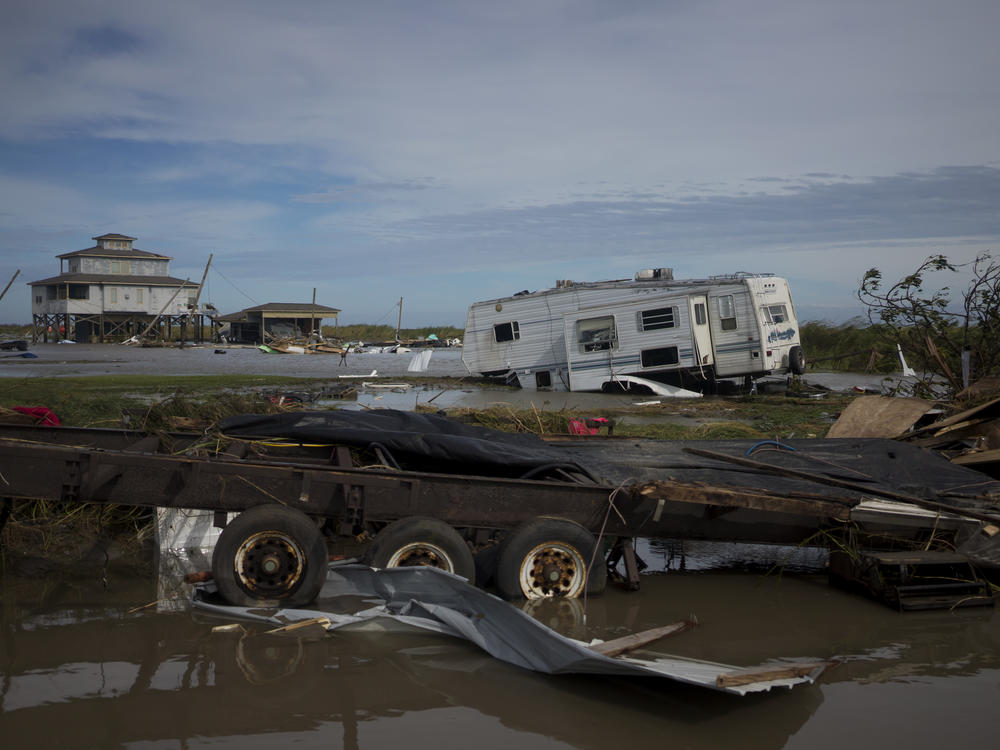A trailer is left damaged and debris scattered Thursday in Holly Beach, La., in the aftermath of Hurricane Laura.