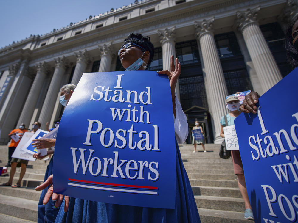 Retired postal worker Glenda Morris protests postal cutbacks on Aug. 25, 2020, in New York. African Americans make up 27 percent of the Postal Service, about twice their share of the overall workforce.
