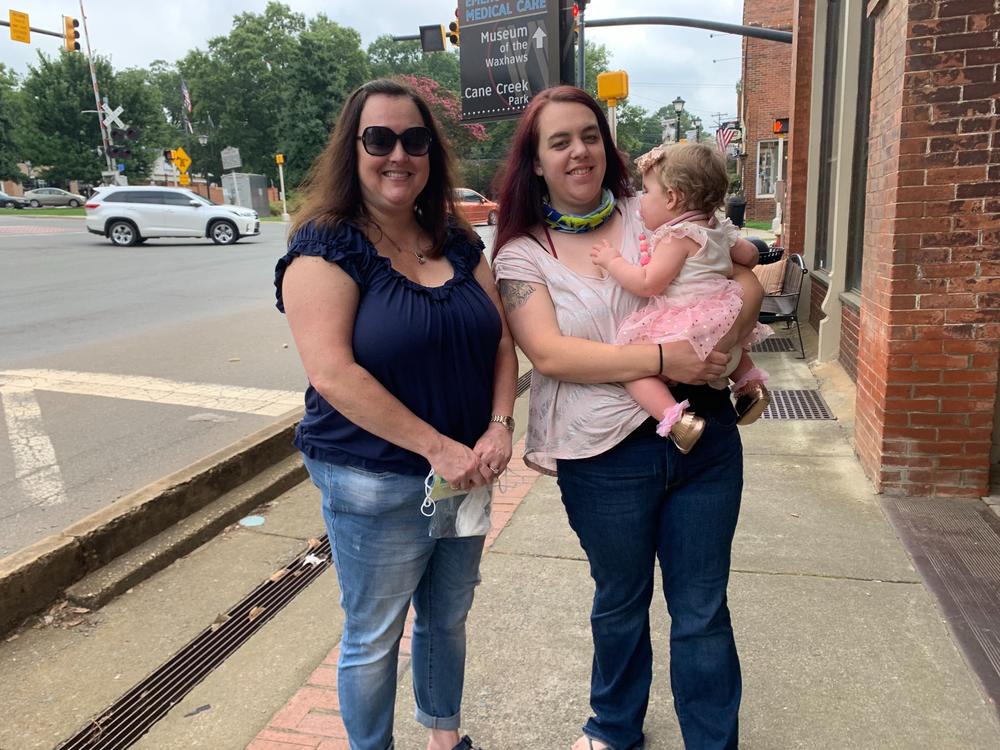 Grandmother Cindy Carroll, daughter Lauren Harrah and 11-month-old granddaughter Austin are headed to a local antique store in the historic district of Waxhaw, N.C. Carroll and Harrah aren't totally sold on President Trump, but they will vote for him over Joe Biden.
