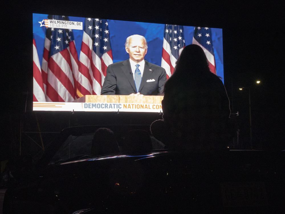 Members of the District of Columbia Democratic Party attend a drive-in watch party in the parking lot of the Robert F. Kennedy Memorial Stadium to watch Democratic presidential nominee Joe Biden accept the Democratic nomination for president on the final night of the Democratic National Convention on August 20, 2020.