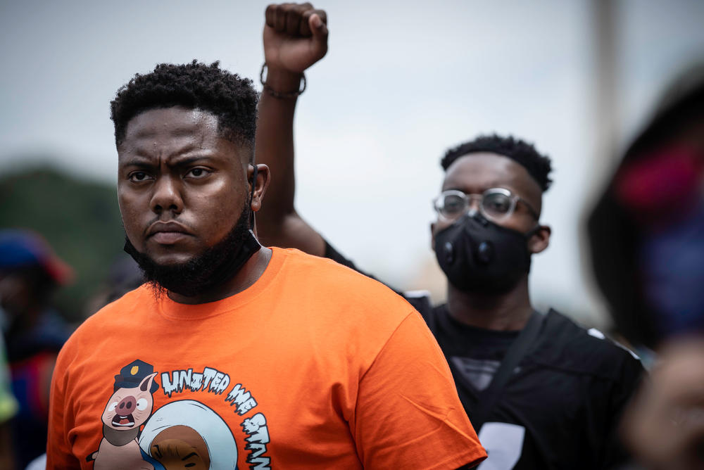 Kalu Abosi, left, and Josh Cobb, both of St. Paul, Minn., listen to the program.