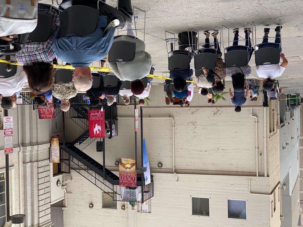 Father Michael O'Reilly preaches from a third-floor fire escape in a Sacramento alley while indoor worship services are prohibited due to COVID-19 heath restrictions.
