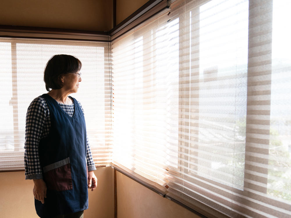 Tomoko stands at the inn in Fukushima prefecture that has been in her family for generations.