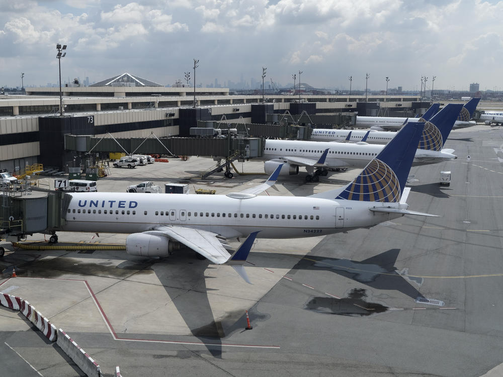 United Airlines planes are parked at gates last month at Newark Liberty International Airport in New Jersey. The airline announced it is eliminating many change fees, and Delta Air Lines and American Airlines quickly followed.