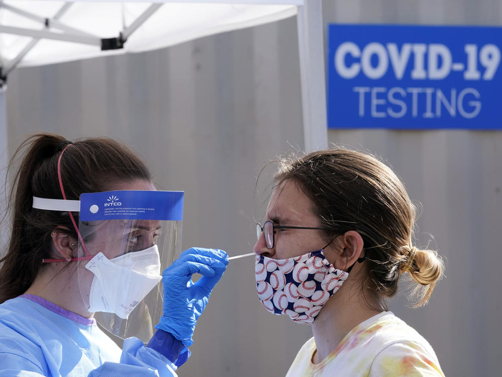 A woman is tested for the coronavirus at a walk-up testing site Friday in Seattle. Testing availability and reliability continue to be problems in the U.S. fight against the virus.