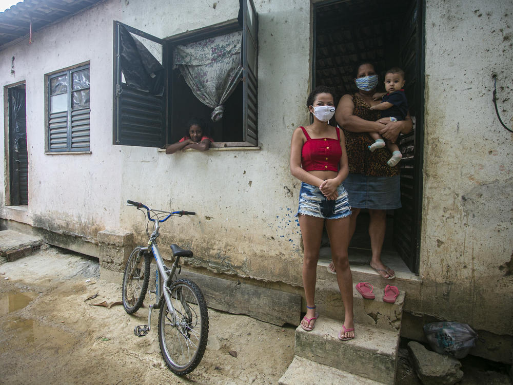 Flaviane da Conceição, 40, a self-employed house cleaner, poses for a photo at her home in the Cidade de Deus favela on July 29 in Rio de Janeiro, Brazil. A single mother of three, she applied for government emergency aid at the beginning of the coronavirus pandemic and it helps her support her family.