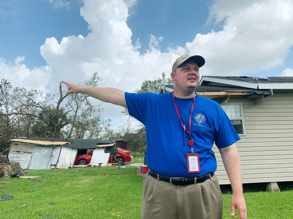 Lake Charles Mayor Nic Hunter visits a neighborhood damaged by Hurricane Laura. Tens of thousands of people will be without electricity for weeks, according to the local utility company.