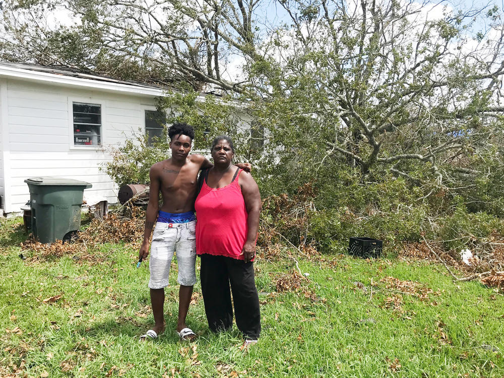 Qwentin Smith and grandmother Gwendolyn Smith stand in front of their home in Lake Charles. Two trees crushed the back of the house when Laura ripped through southwest Louisiana.