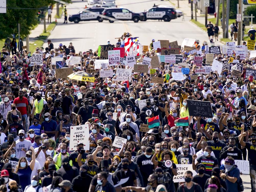 Demonstrators march at a rally Saturday for Jacob Blake in Kenosha, Wis. Officials lifted a nightly curfew on Wednesday, saying recent protests had been relatively peaceful.