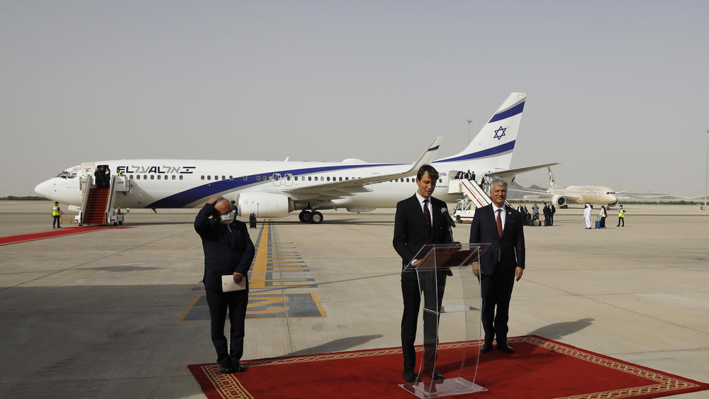 White House senior adviser Jared Kushner speaks as Israeli national security adviser Meir Ben-Shabbat, left, and U.S. national security adviser Robert O'Brien listen after an El Al plane from Israel landed in Abu Dhabi, United Arab Emirates, Monday. The Israeli flag carrier's flight marks a U.S.-brokered deal to normalize relations between Israel and the UAE.