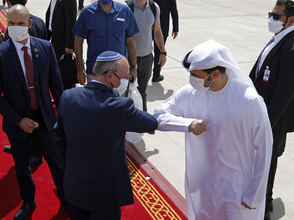 Israeli national security adviser Meir Ben-Shabbat, left, elbow-bumps an Emirati official as he departs Abu Dhabi, United Arab Emirates, Tuesday.