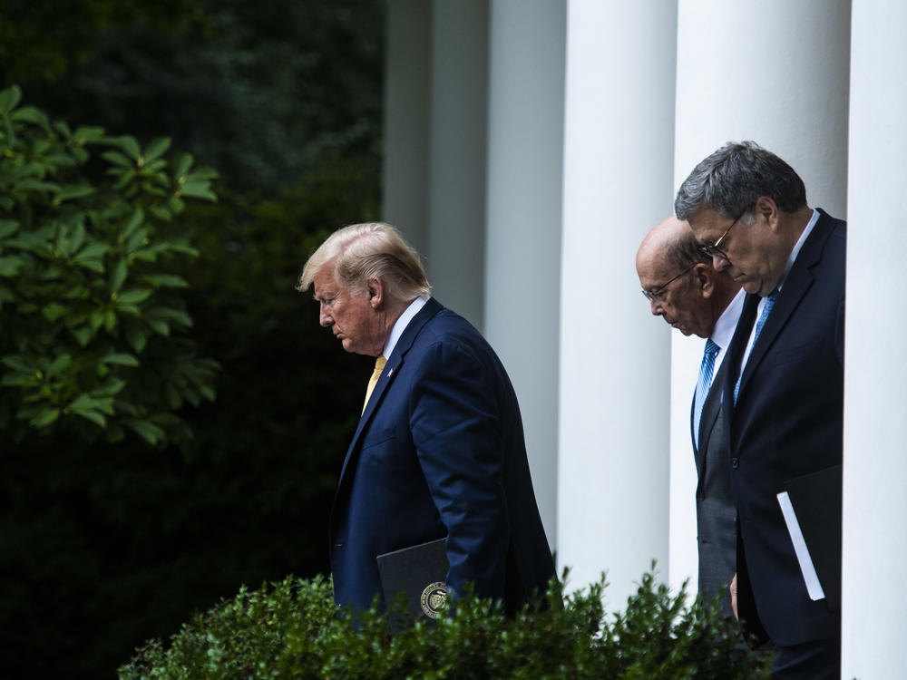 President Trump, Commerce Secretary Wilbur Ross (center) and Attorney General William Barr walk into the White House Rose Garden for a July 2019 press conference on the census.