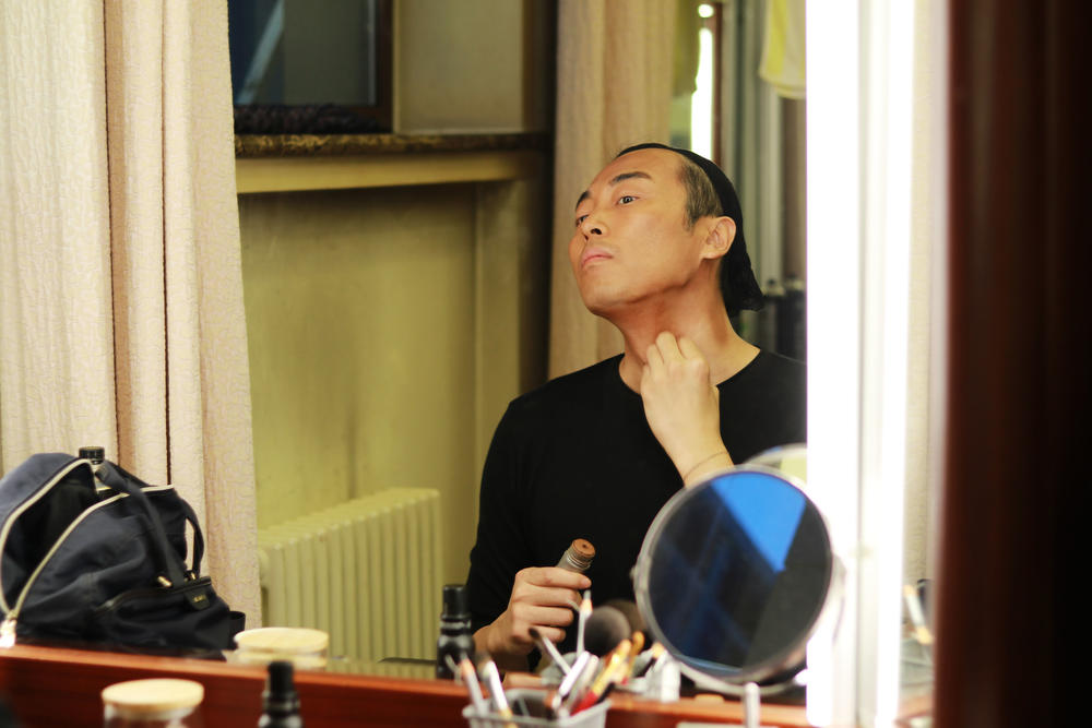 Actor Jin Han, who plays Walter Lee Younger, powders on dark stage make up on opening night of the production on Sept. 1.