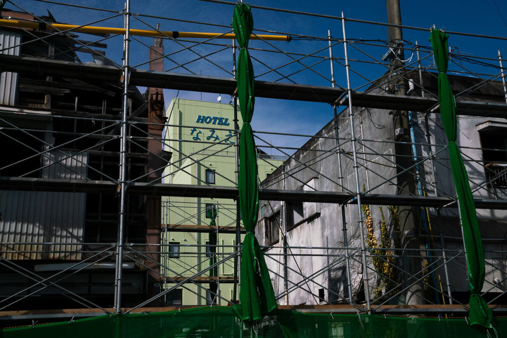 Construction scaffolding is set up in front of some of Namie's downtown buildings. Namie has reopened and is starting to come back to life — even if only a fraction of the population has returned.