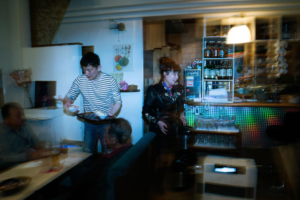 Cosmos Karaoke is a lively karaoke bar in the middle of Namie, a small city that is slowly reopening after the 2011 earthquake, tsunami and nuclear accident devastated the area. Minza Lee (right) is the driving force behind the bar.