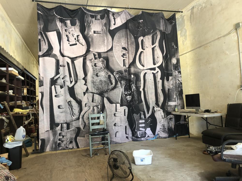 Timothy Duffy's enlarged photo of Freeman Vines' unfinished guitars hanging in Vines' workroom.
