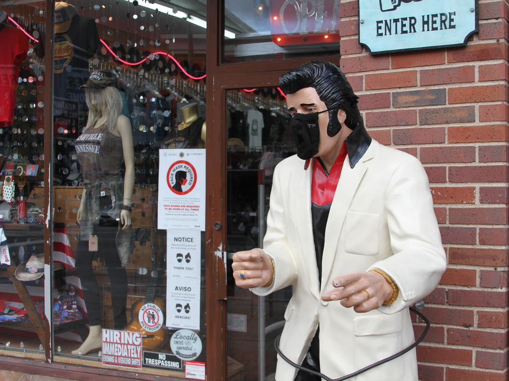 An Elvis Presley statue on Nashville's Lower Broadway wears a state-issued mask.