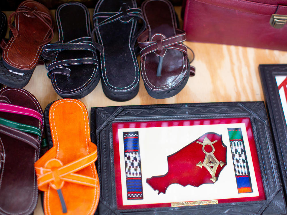 Leather sandals, made by Saley, on display along with other items.