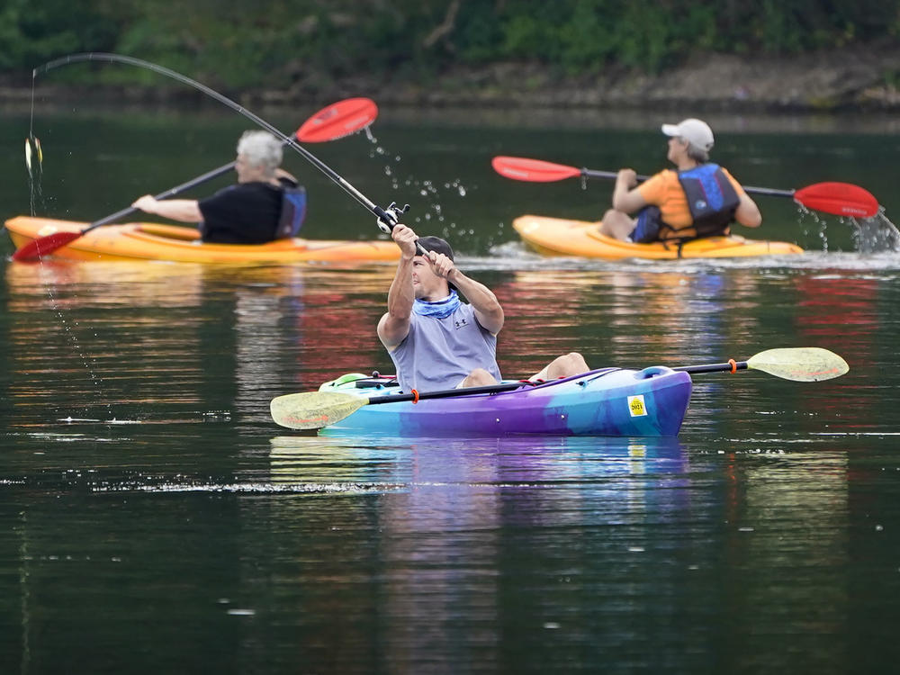A fisherman in a kayak makes a cast on Lake Arthur at Moraine State Park in Portersville, Pa. Sales of camping, outdoor and recreational equipment have been surging.