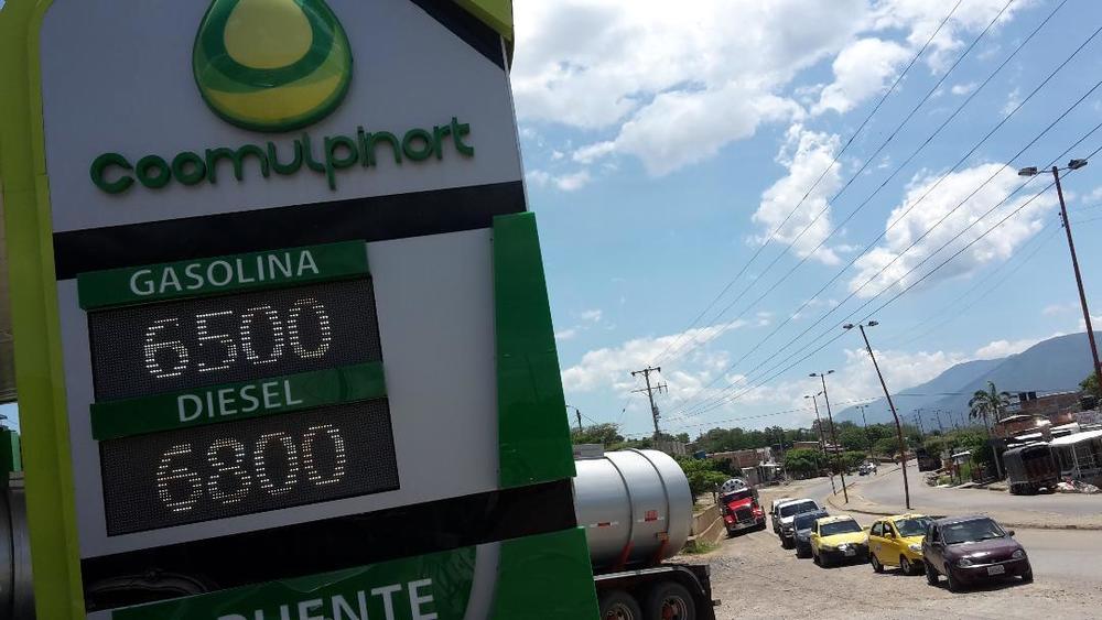 A gas station belonging to a chain operated by a business co-op, in the Colombian border city of Cúcuta, lists regular gas at 6,500 pesos ($1.75) and diesel at 6,800 pesos ($1.84) per gallon.