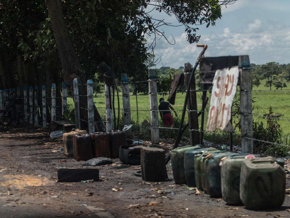 Contraband fuel sits on the side of a road in Puerto Santander, Colombia, on May 31, 2019. The Venezuelan government's lack of cash to import gasoline combined with U.S. sanctions targeting the oil sector have led to chronic fuel shortages in Venezuela. That has upended a long-running, lucrative contraband gas trade.