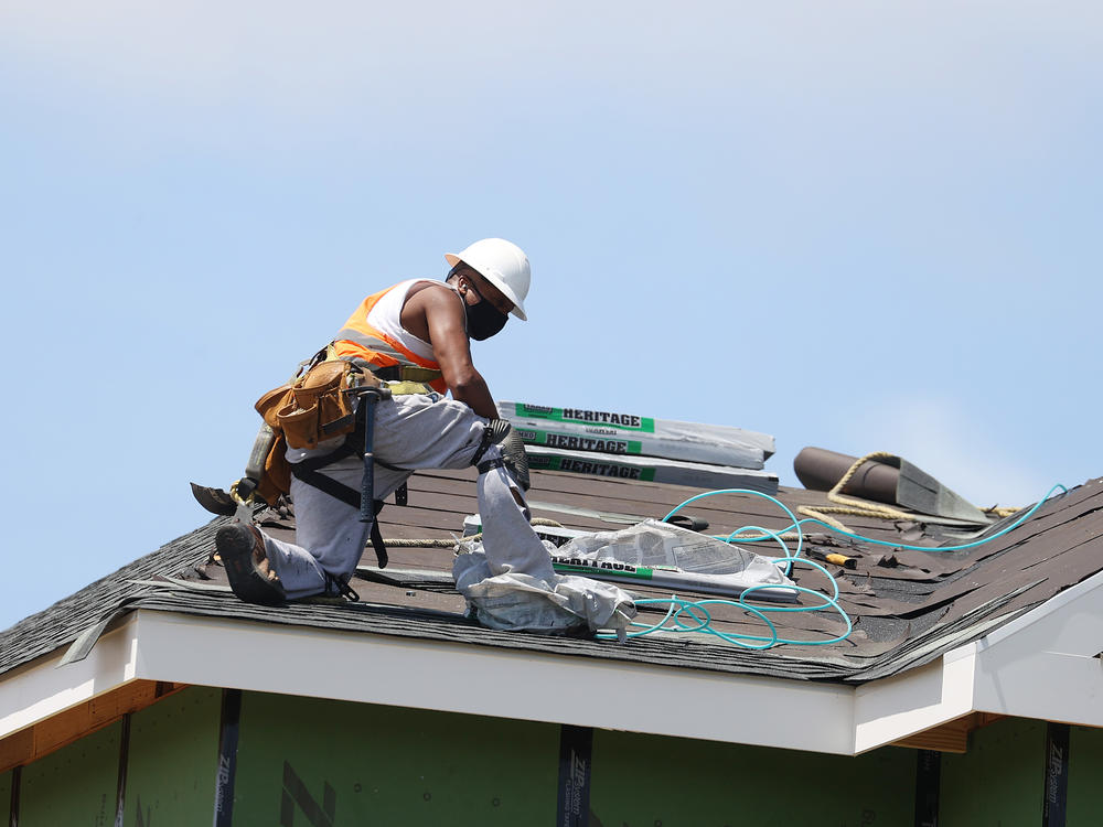 A construction worker roofs an apartment complex in Uniondale, N.Y., on May 27. U.S. employers added fewer jobs last month even as the unemployment rate fell to 8.4%.