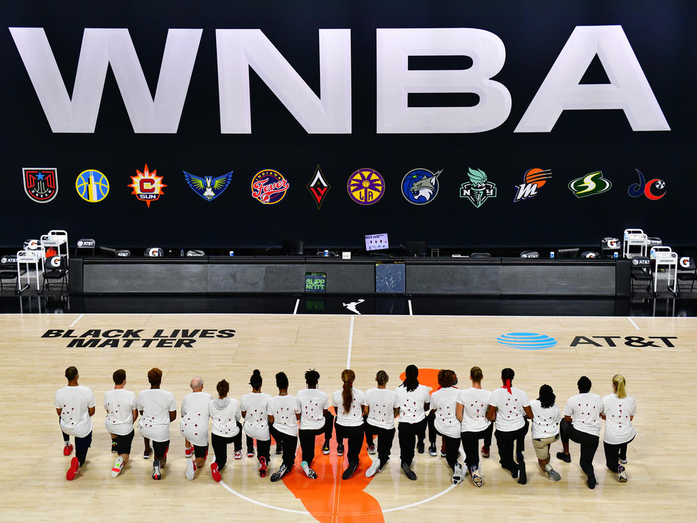After the WNBA announcement of the postponed games for the evening, the Washington Mystics each wear white T-shirts with seven bullets on the back protesting the shooting of Jacob Blake by Kenosha, Wisconsin police at Feld Entertainment Center on August 26, 2020 in Palmetto, Florida.