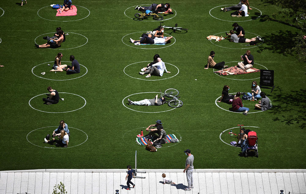 Signs and circles — directing people where to move, stand, or lie down — popped up in many public spaces including in Brooklyn's Domino Park.