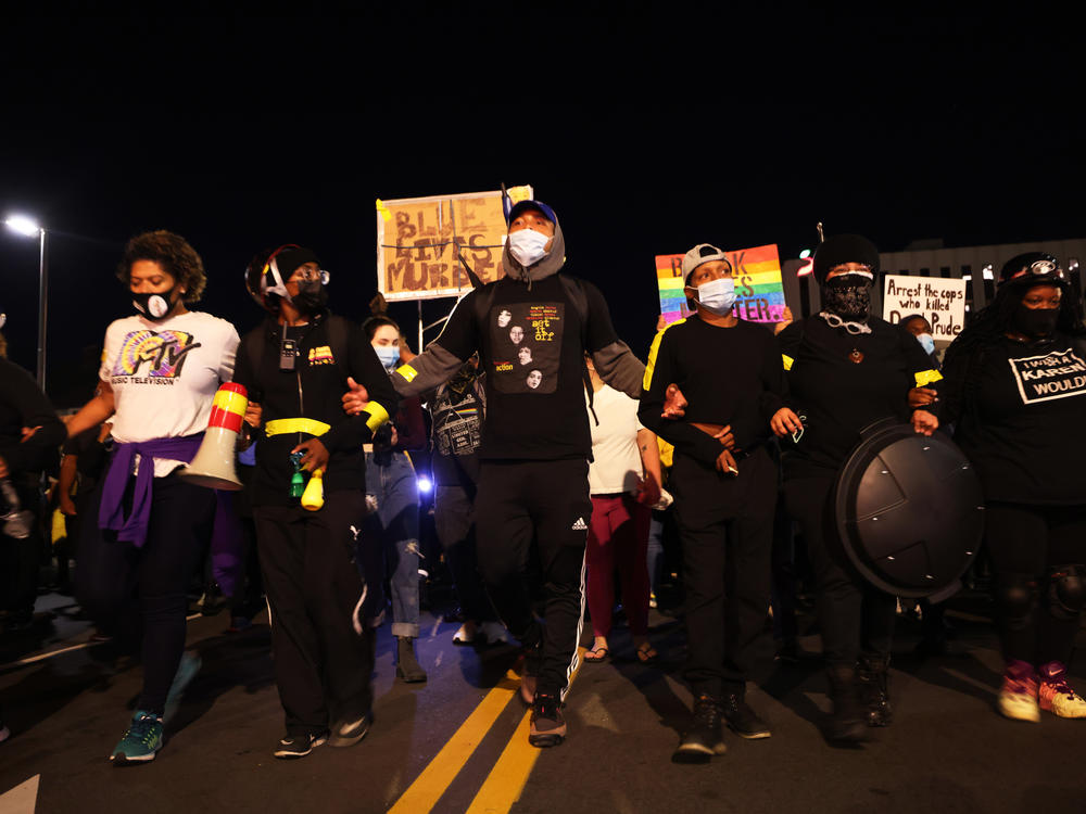 Demonstrators lock arms as they march for Daniel Prude on Friday in Rochester, N.Y. Prude died after being arrested on March 23 by Rochester police officers, who had placed a 