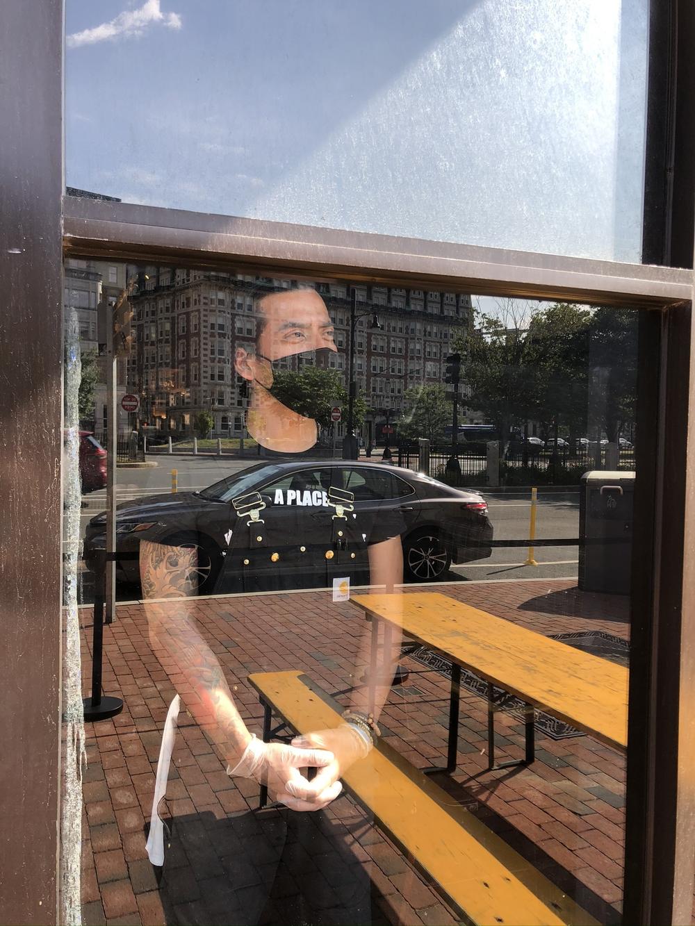On Cornwall's first day open since the pandemic, business is slow, leaving server Miz Martinez long stretches of time to gaze out the window at the empty streets,  in the once-bustling Kenmore Square.