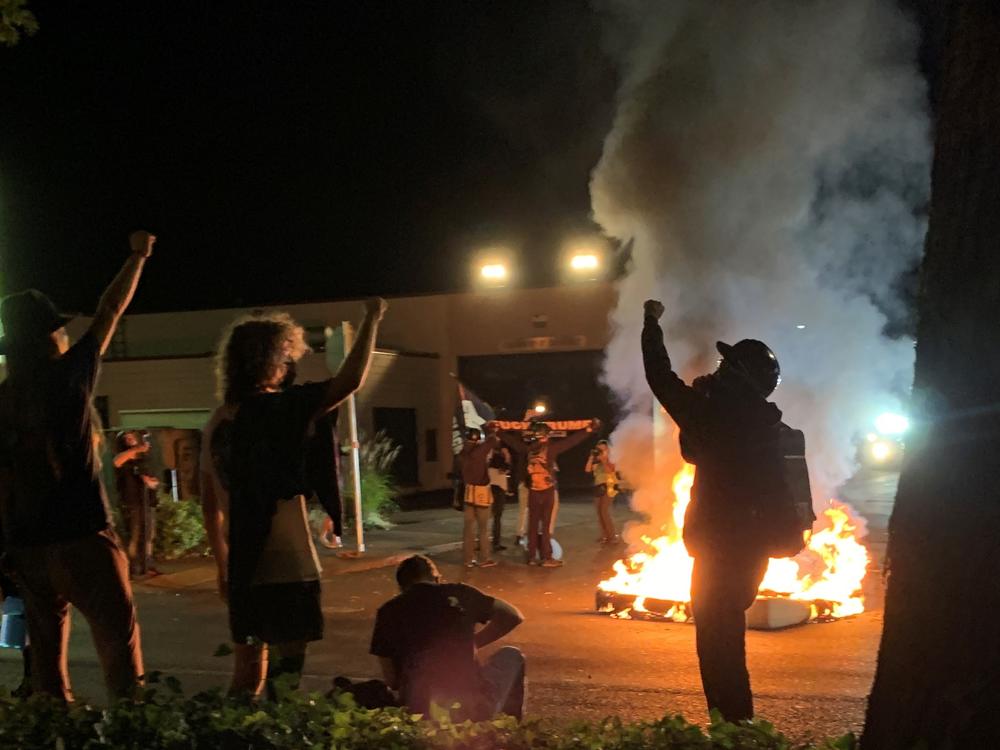 Portland protesters set fire to two mattresses across the street from the Portland Police Bureau's north precinct on Sunday night.
