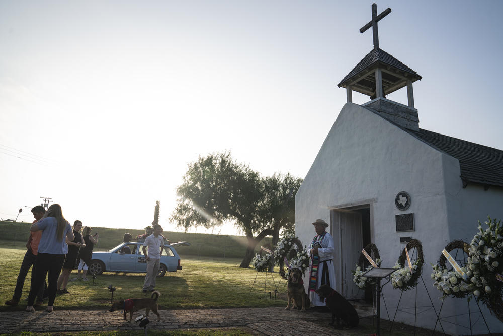 Father Roy Snipes and mass attendees make their way to the Rio Grande where they will be releasing memorial wreaths with the names of the asylum-seekers that died trying to reach the U.S. in Mission, Texas.
