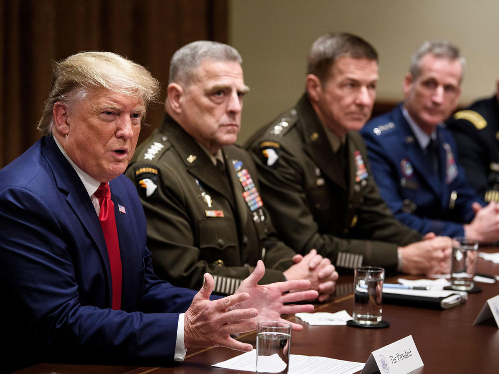 Army Gen. Mark Milley (second from left), chairman of the Joint Chiefs of Staff, and others listen as President Trump speaks during a meeting with senior military leaders in October.