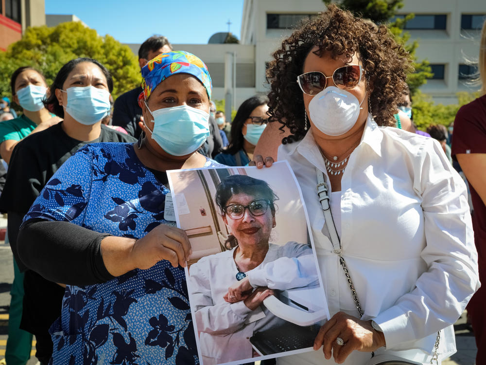 Worried registered nurses held a vigil in July at Sutter Health's Alta Bates Summit Medical Center in Oakland, Calif., to remember their colleague Janine Paiste-Ponder, who caught COVID-19, likely from a patient, and died from complications.