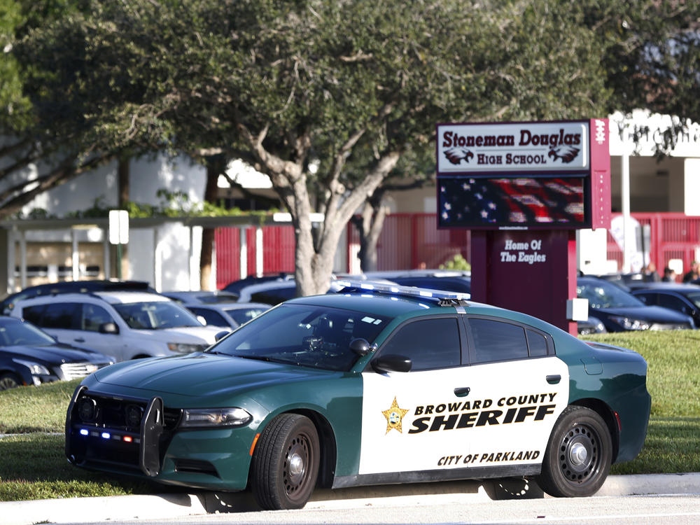 A Broward County Sheriff's Office vehicle is parked outside Marjory Stoneman Douglas High School, in Parkland, Fla.