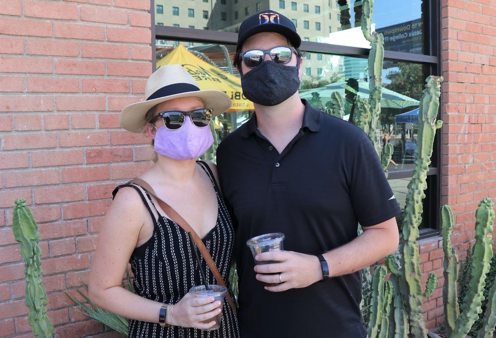 Kevin Wood and Rachael McDermott pose for a masked portrait at a farmer's market in Phoenix.