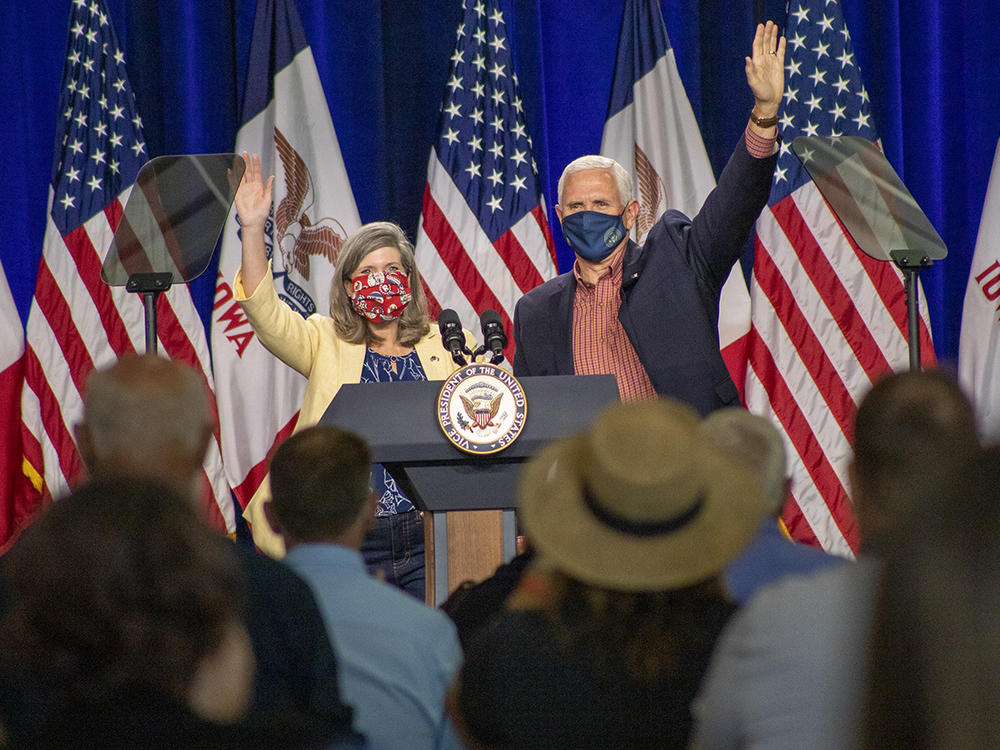 U.S. Sen. Joni Ernst, R-Iowa, appears on stage with Vice President Mike Pence in Des Moines on Aug. 13. Ernst is locked in a close race for reelection this fall against Democrat Theresa Greenfield.