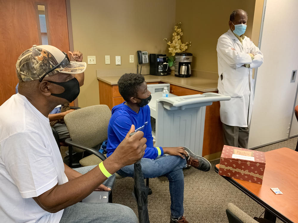 Robert Smith of Nashville listens to his long-time physician, Dr. Vladimir Berthaud of Meharry Medical College, explain the importance of Black patients participating in clinical trials for the COVID-19 vaccine. Berthaud is leading the project at the historically black medical school.