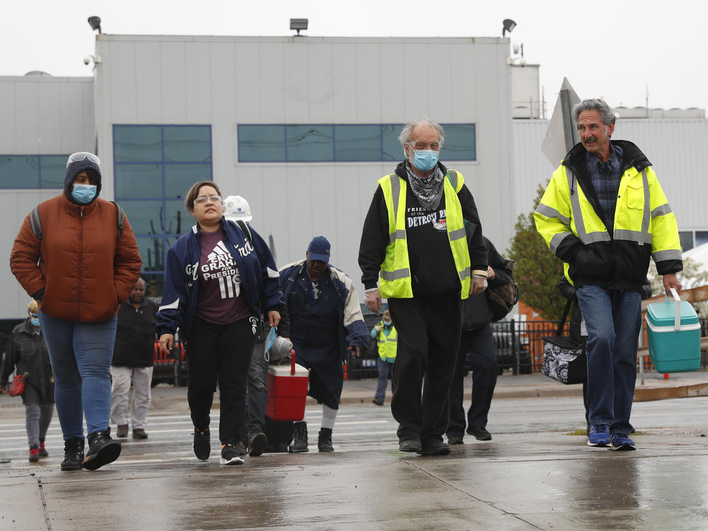 United Auto Workers members leave the Fiat Chrysler Automobiles Warren Truck Assembly plant after a shift in May in Warren, Mich. Car sales are picking up again, but automakers face a problem: getting enough workers.