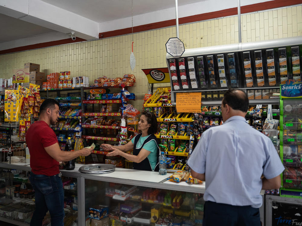 A person buys soda at a convenience store in San Luis Potosi, Mexico, on April 13. The country has high levels of obesity and medical conditions that health authorities warn are related to a diet high in soda and processed foods.