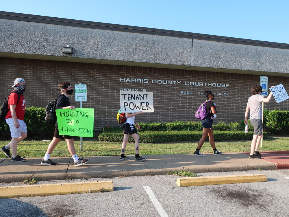 Protesters march Aug. 21 outside a courthouse in Houston, where evictions are continuing despite a moratorium ordered recently by the Centers for Disease Control and Prevention.