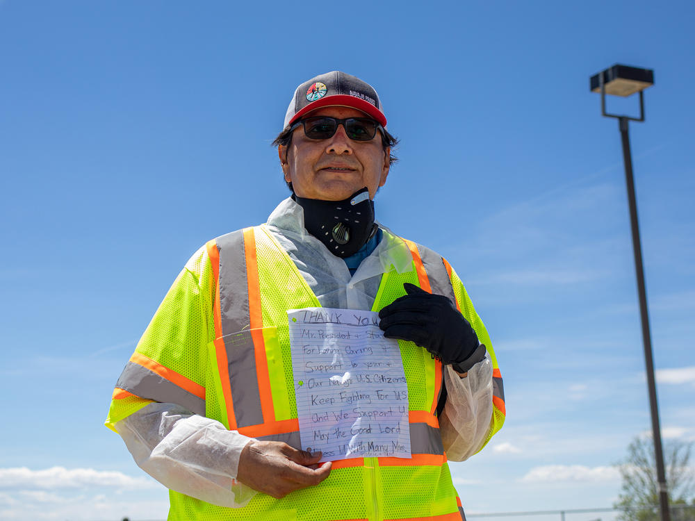 Navajo Nation President Jonathan Nez holds a letter from a Navajo family while distributing food, water and other supplies on May 27, on the Navajo Nation Reservation in New Mexico.
