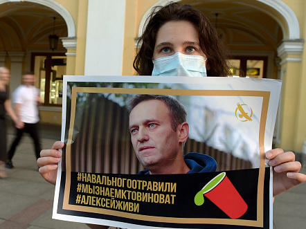 A woman holding a placard with an image of Alexei Navalny expresses support for the opposition leader in downtown St. Petersburg last month.