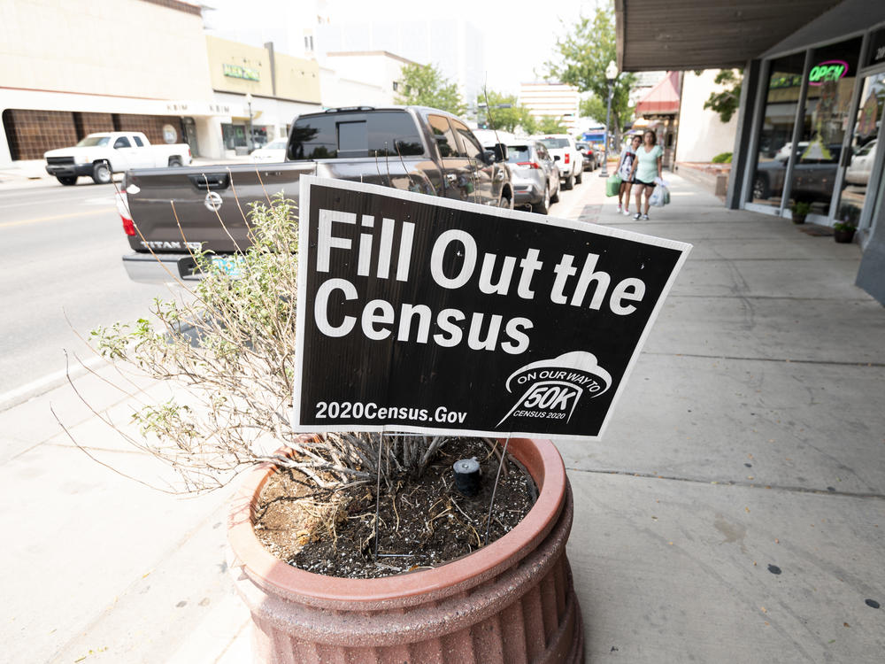 A sign promoting the 2020 census stands in a planter in Roswell, N.M., in August. A federal judge has ordered the Trump administration to continue holding off on wrapping up the census for now.