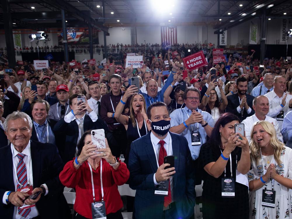 People cheer as President Trump arrives for an indoor campaign rally Sunday night at Xtreme Manufacturing in Henderson, Nev.