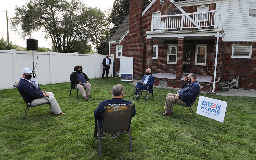 Democratic presidential nominee Joe Biden talks with members of the United Steelworkers union in a supporter's backyard last week in Detroit.