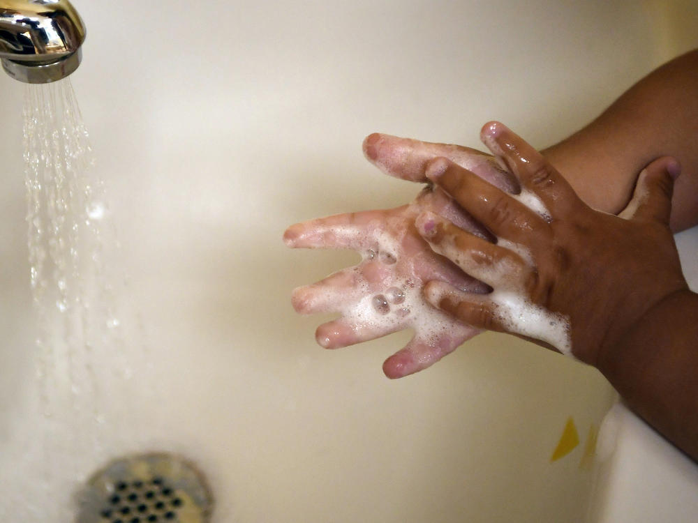 A child washes her hands at a day care center in Connecticut last month. A detailed look at COVID-19 deaths in U.S. kids and young adults by the Centers for Disease Control and Prevention shows the great majority are children of color.