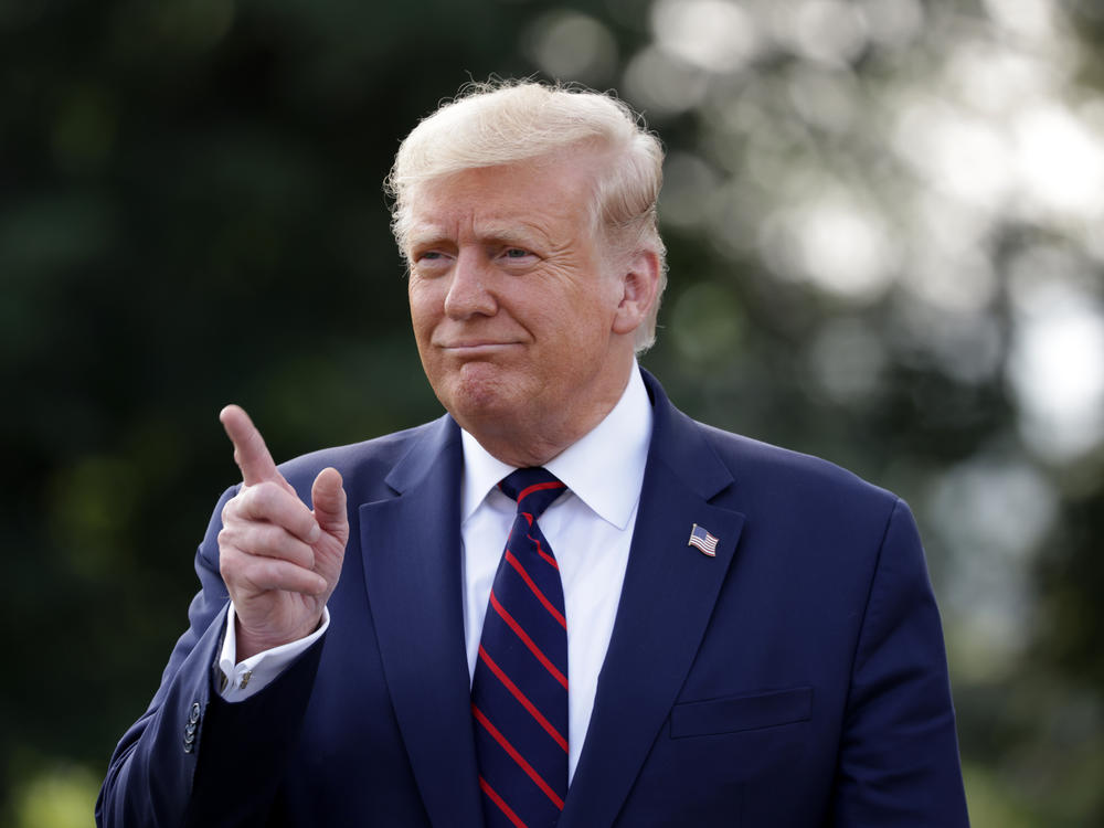 President Trump speaks to members of the press at the White House on Tuesday. On Wednesday, Trump praised the Big Ten's decision to resume the college football season at the end of October.