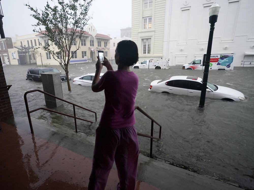 Floodwaters swamp cars on a street in downtown Pensacola, Fla., Wednesday. Hurricane Sally made landfall near Gulf Shores, Ala., as a Category 2 storm, pushing a surge of ocean water and dumping torrential rainfall.